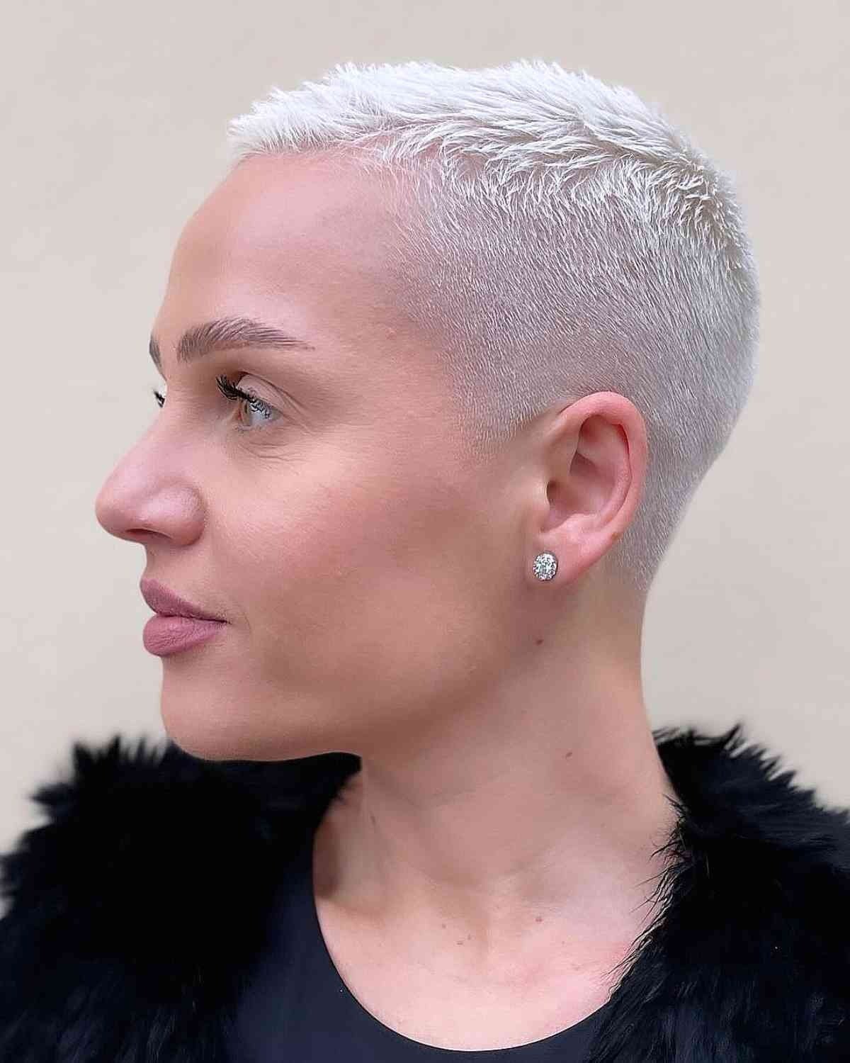 Close-up of a sleek platinum blonde buzz cut gender neutral hair