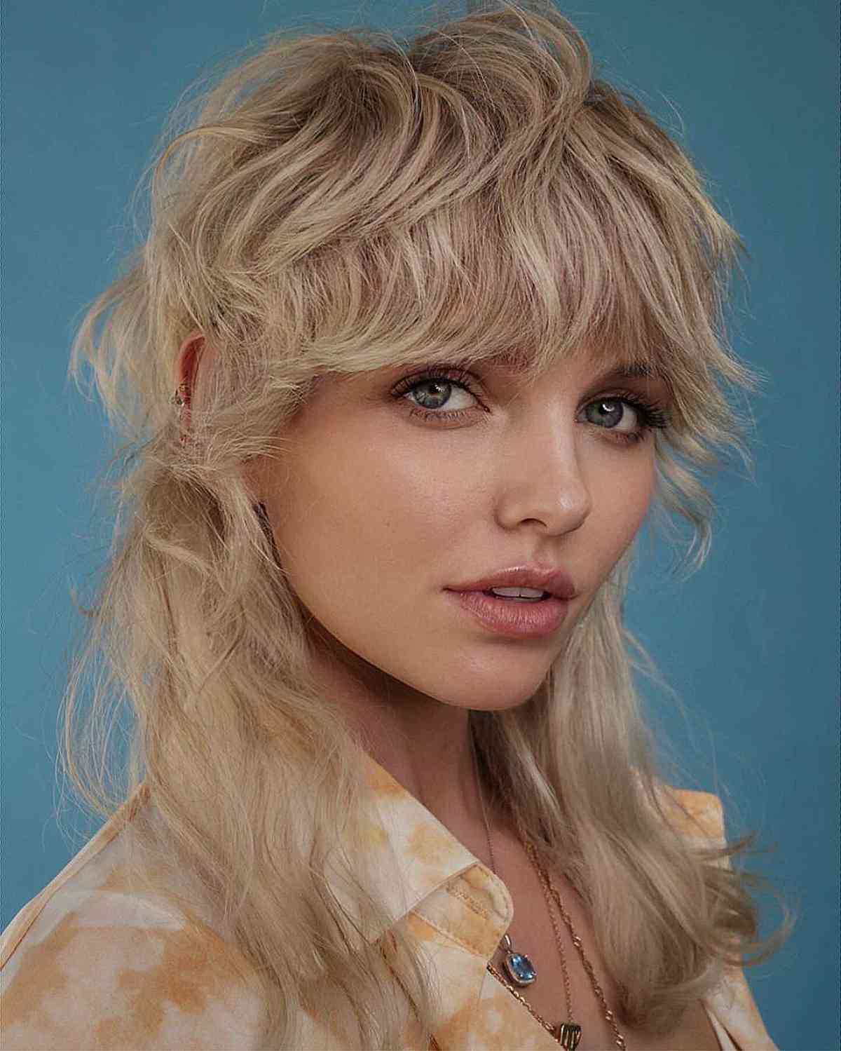 Soft blonde shag haircut with inclusive layered bangs