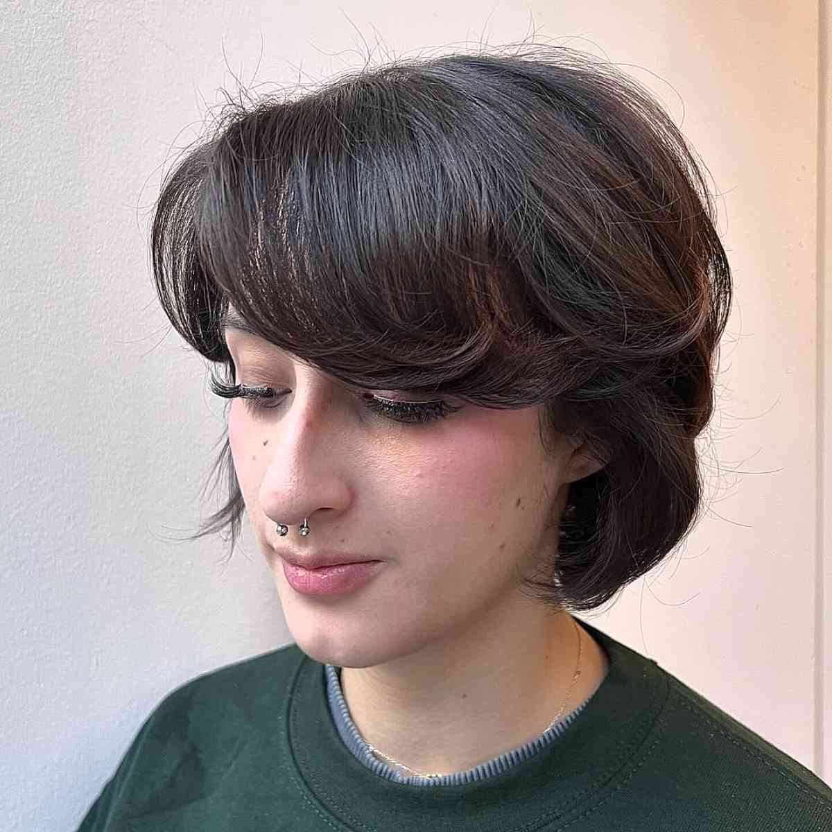 Soft layered bob gender neutral haircut with face-framing bangs