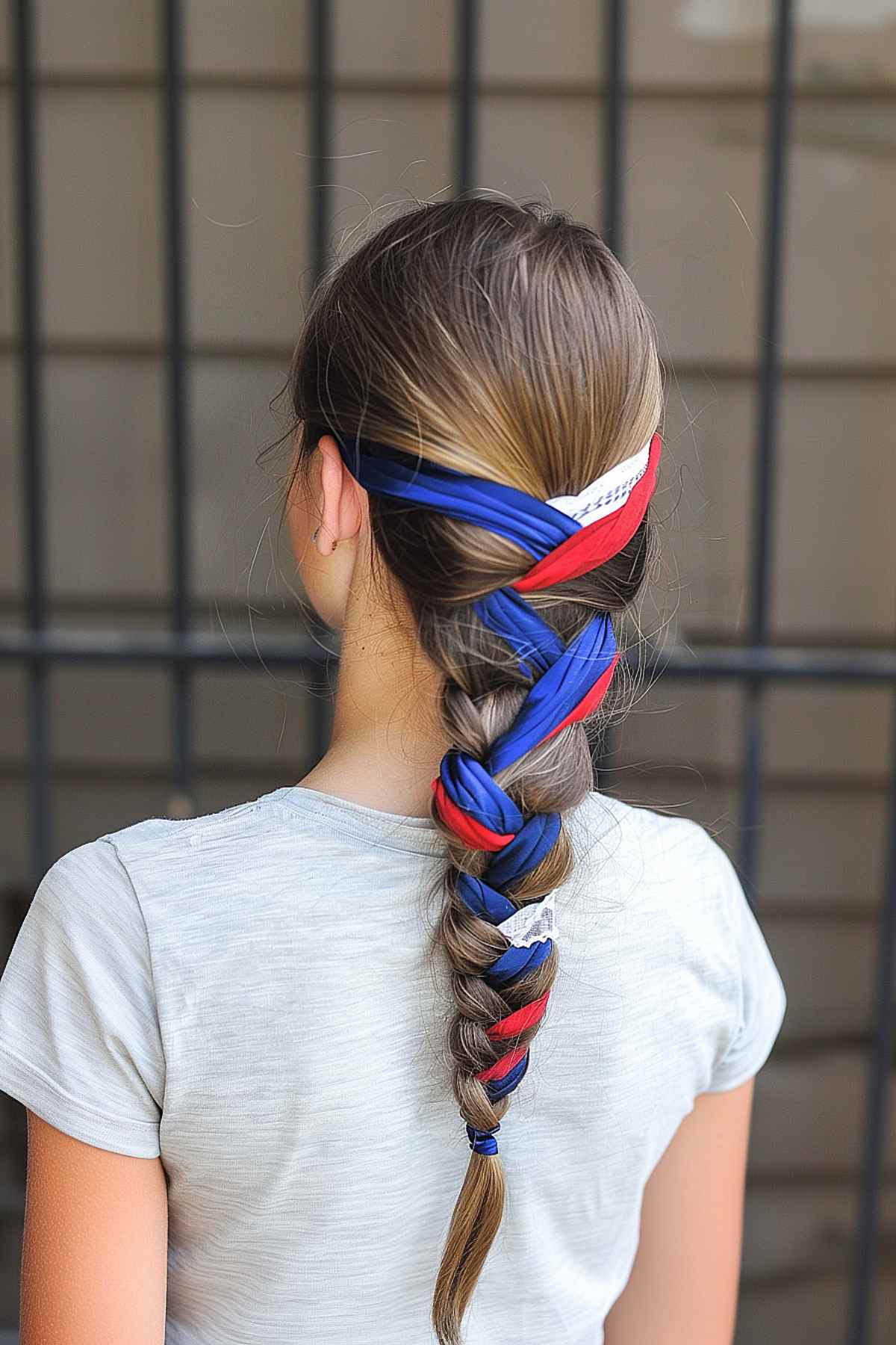 Medium length hair in a French braid with red, white, and blue ribbons for 4th of July