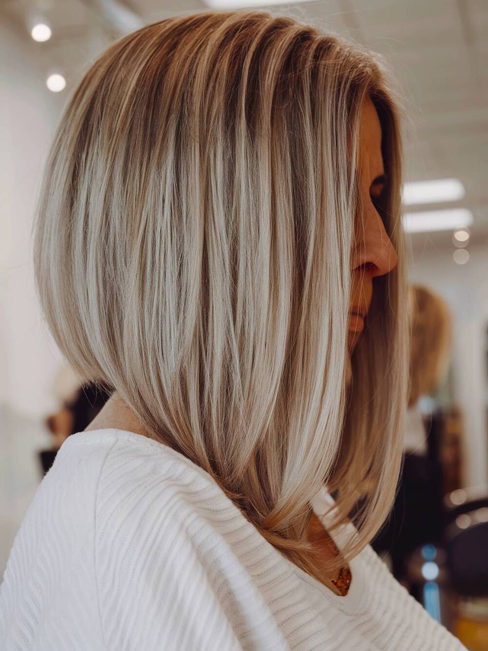 Sleek inverted bob with tapered ends, creating a sharp yet sophisticated silhouette