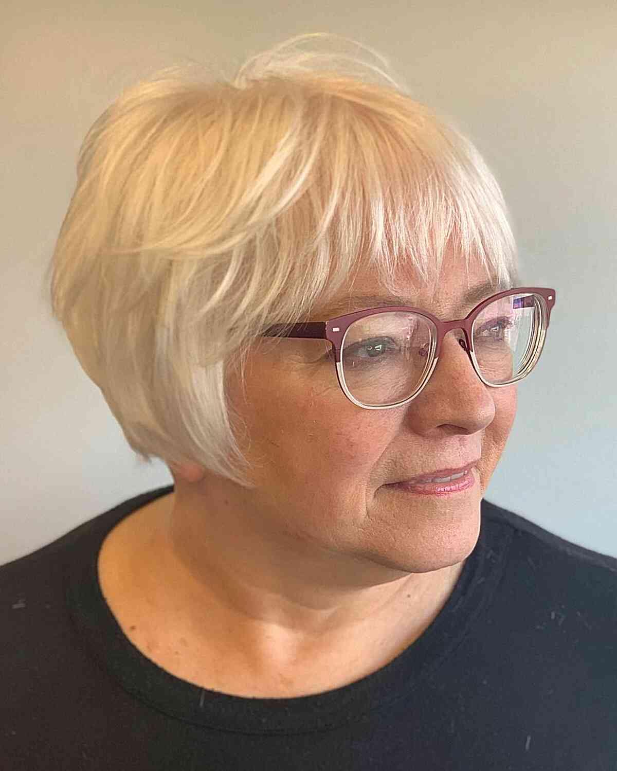 Jaw-Grazing White French Bob with Choppy Bangs for Women Aged 60 with Fine Hair and Glasses