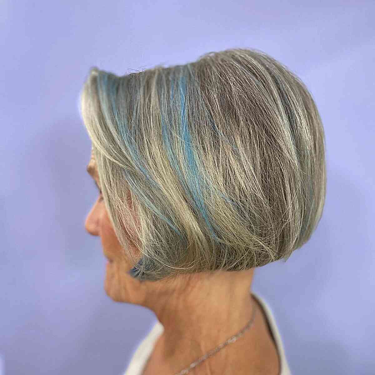 Short Salt-and-Pepper Bob with Blue Accents for Modern Ladies Aged 60