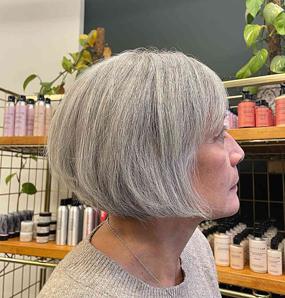 Jaw-Length Silver Bob with a Side Fringe on a Dense Hair Type for women aged 50