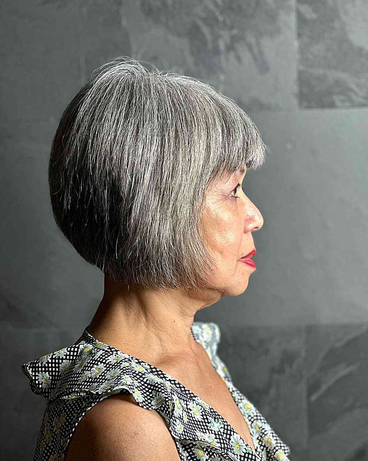 Jaw-Length Triangular Graduated Cut with Fringe for Women Aged 70 with Grey Hair