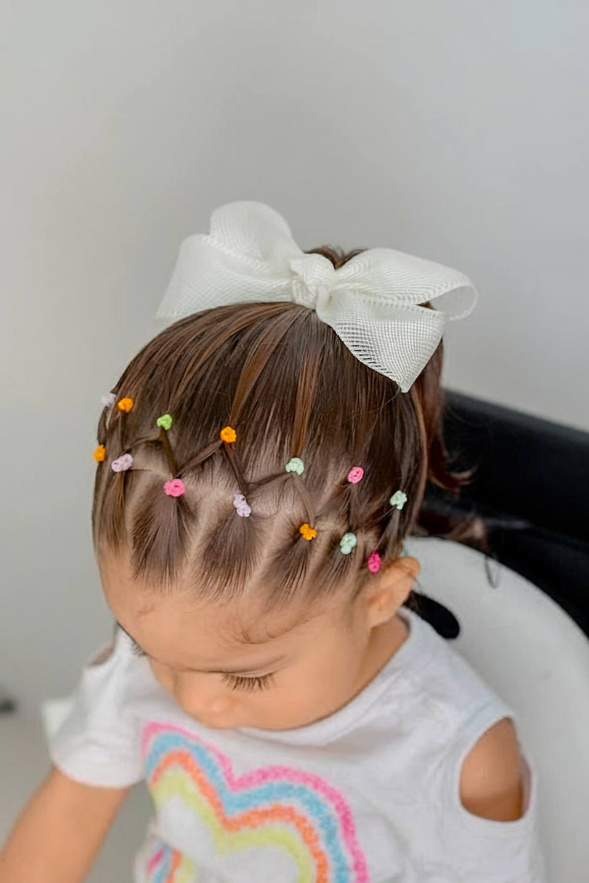 Christmas toddler hairstyle with elastics and a bow