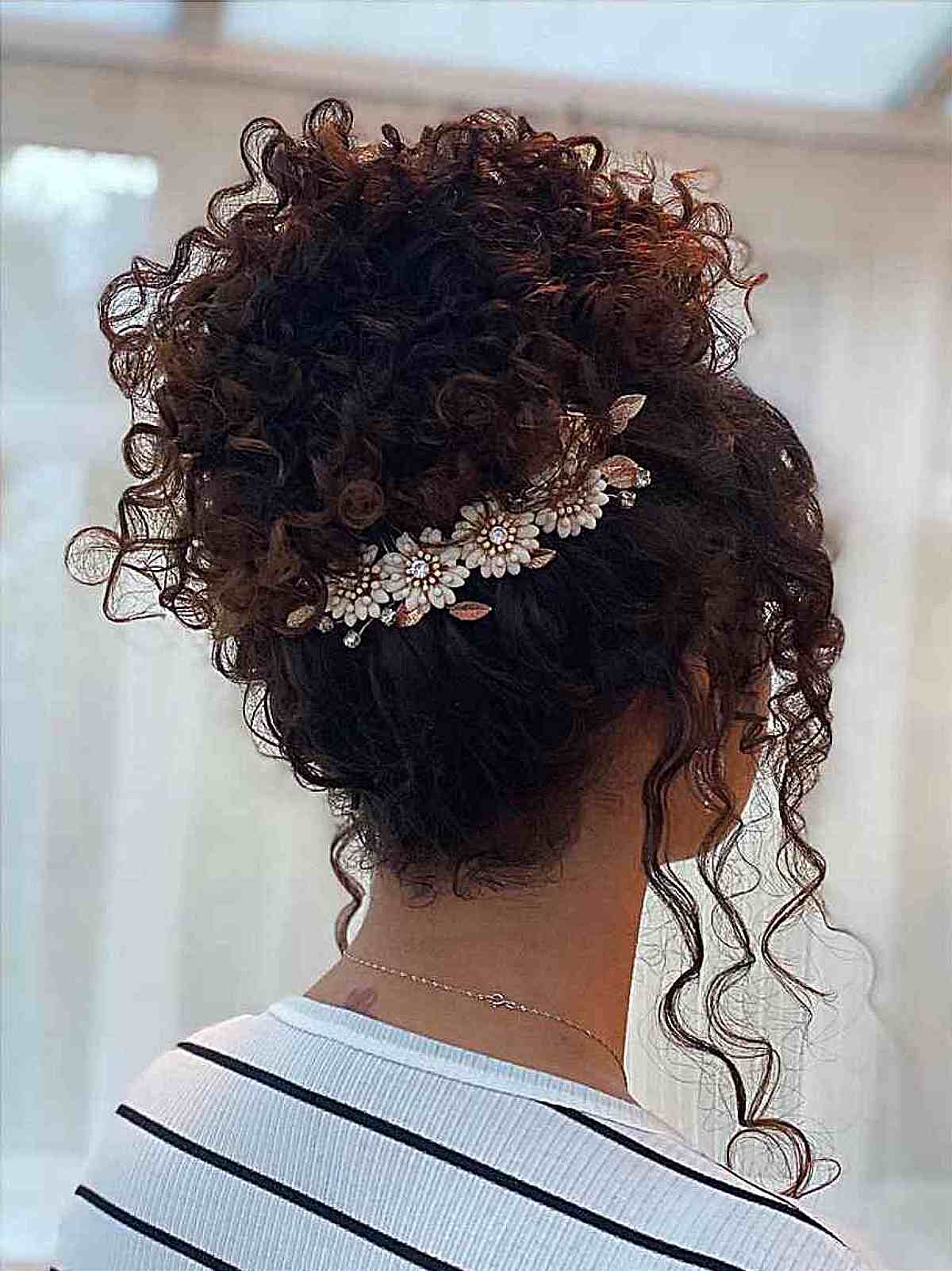Kinky Bun Updo with Face-Framing Curls and a Floral Hair Wrap for prom