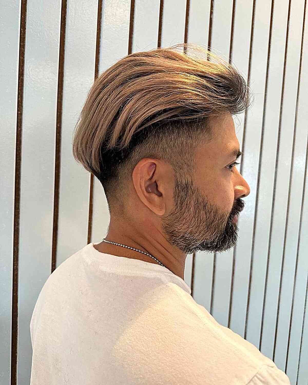 Korean-Inspired Long Slicked Back with Shaved Sides for Men with Beard
