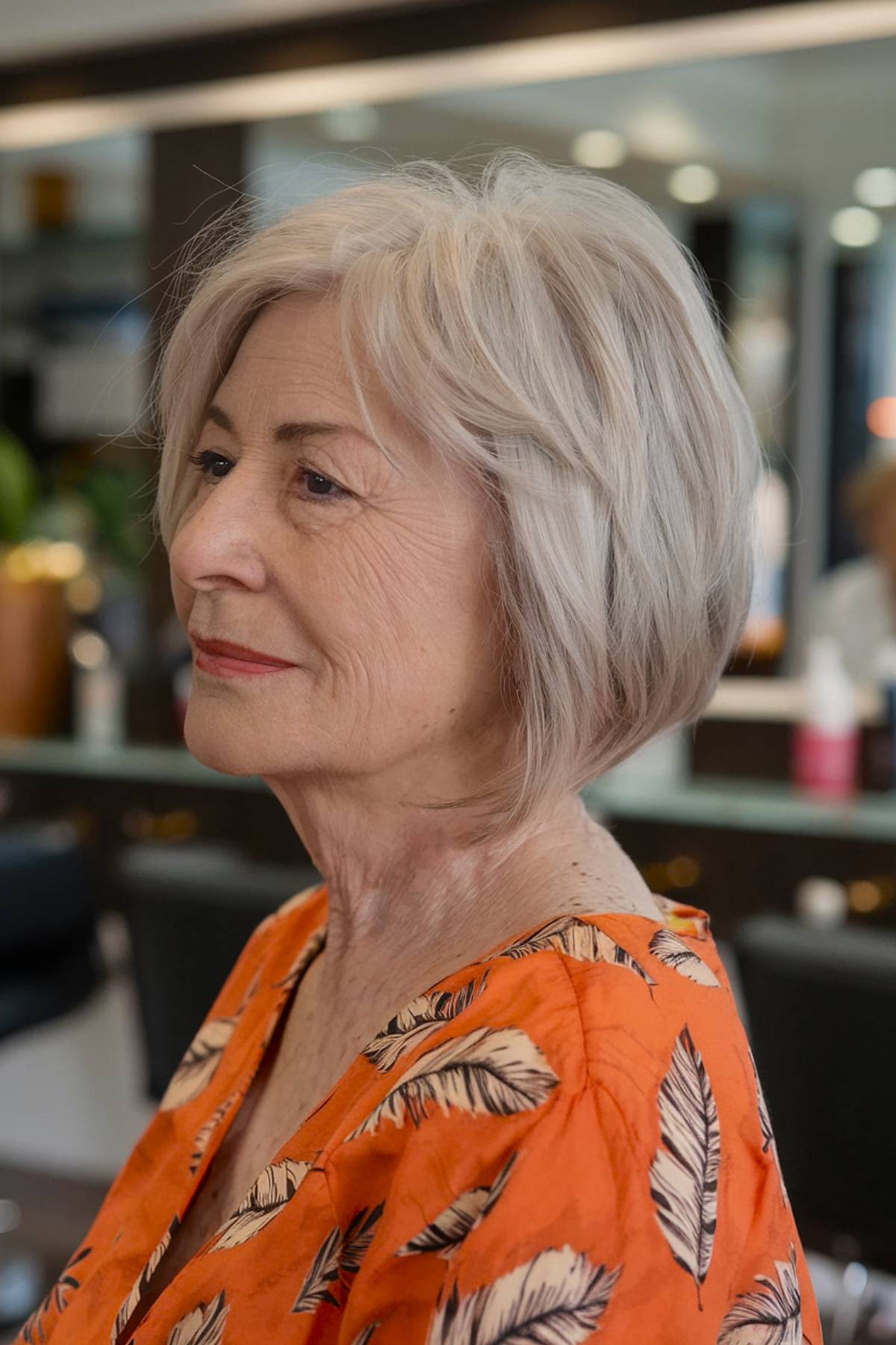 A soft, layered angled bob with feathered ends, creating natural movement for older women wanting a youthful, voluminous style