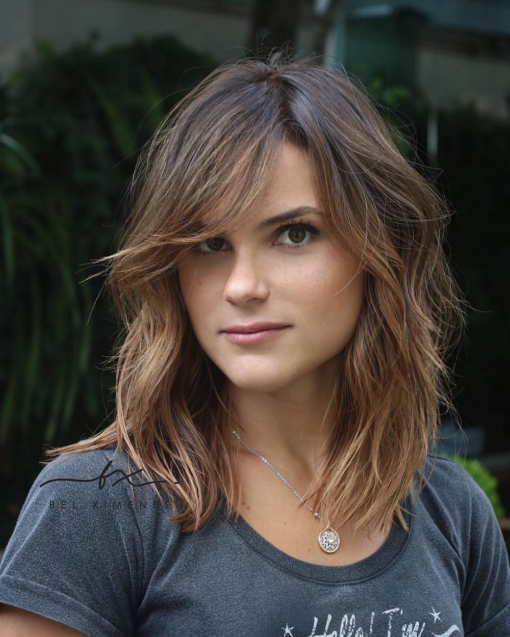 layered hair with side-swept bangs