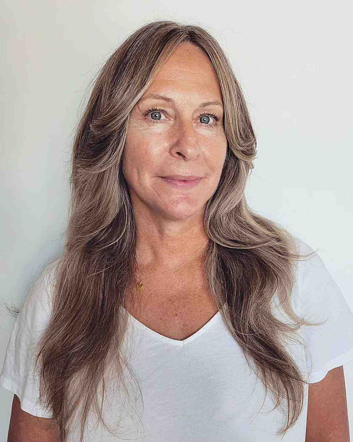 Layered Long Hair with Center Part on Women Over 60