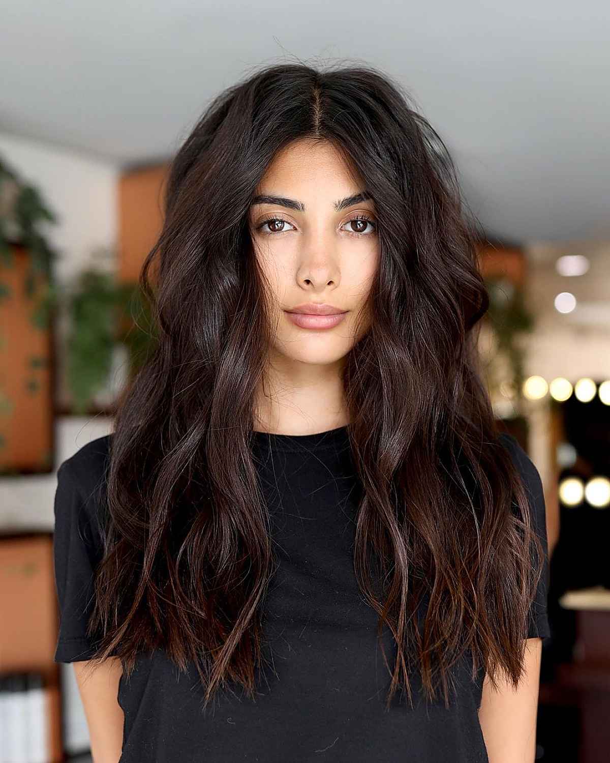 layered long haircut with middle parted bangs