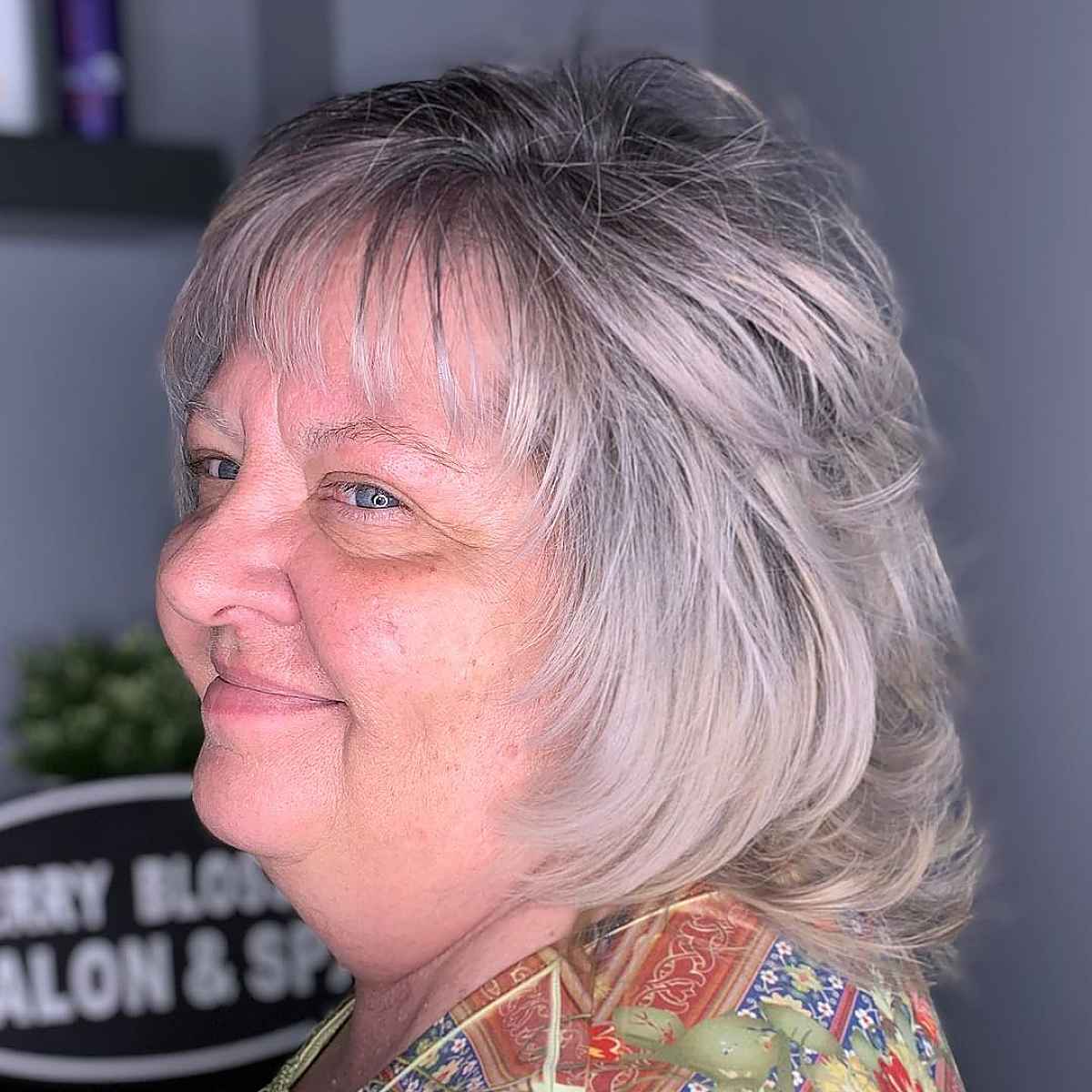 Layered Shaggy Haircut with Wispy Bangs for Round Faces
