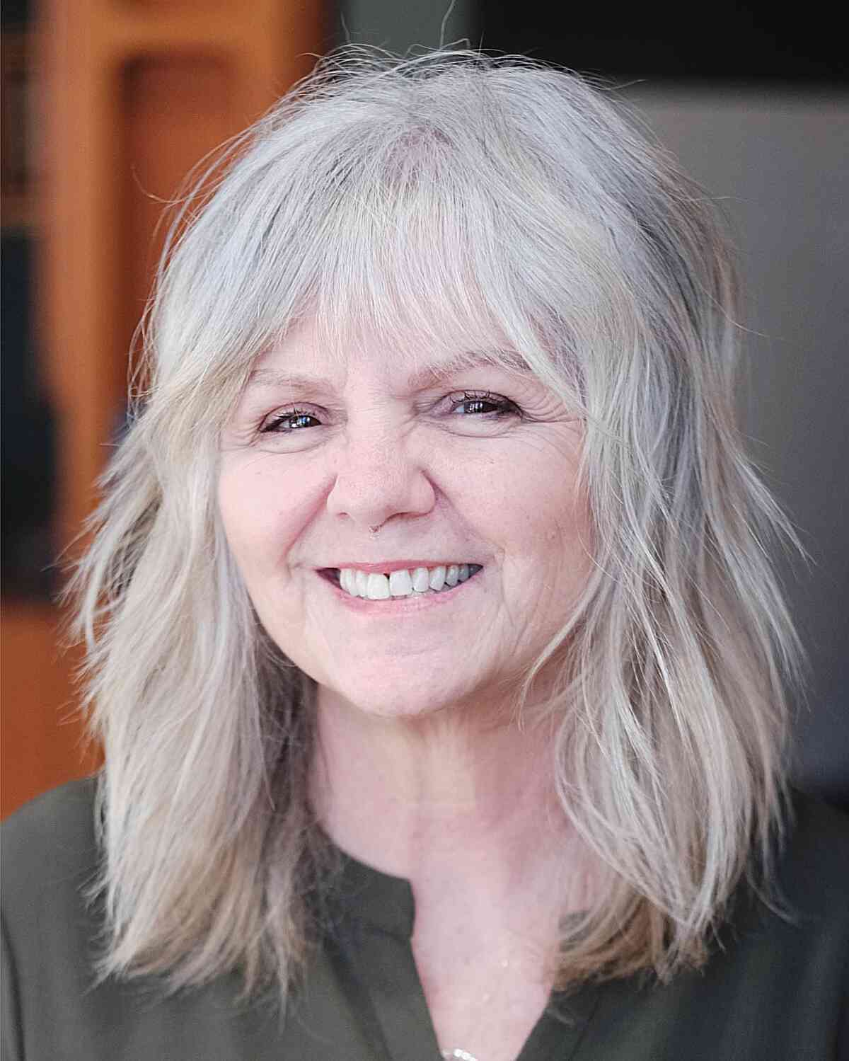 Layered Shaggy Medium-Length Cut for Round-Faced Women Aged 60