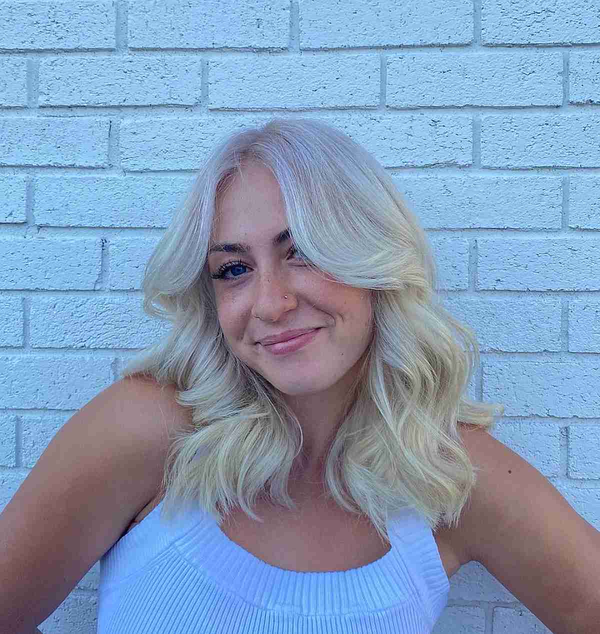 Layered Shoulder-Length Waves with a Center Part for Thick-Haired Blonde Women