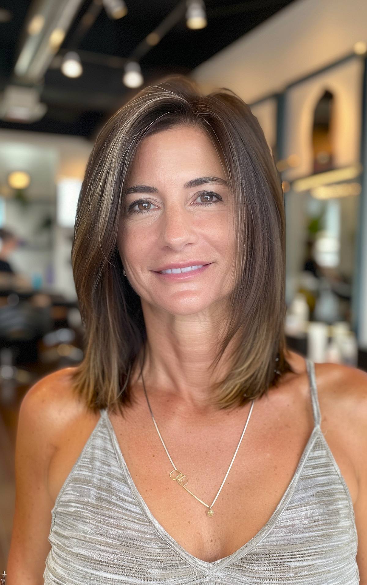 Layered straight shoulder-length haircut with face-framing layers