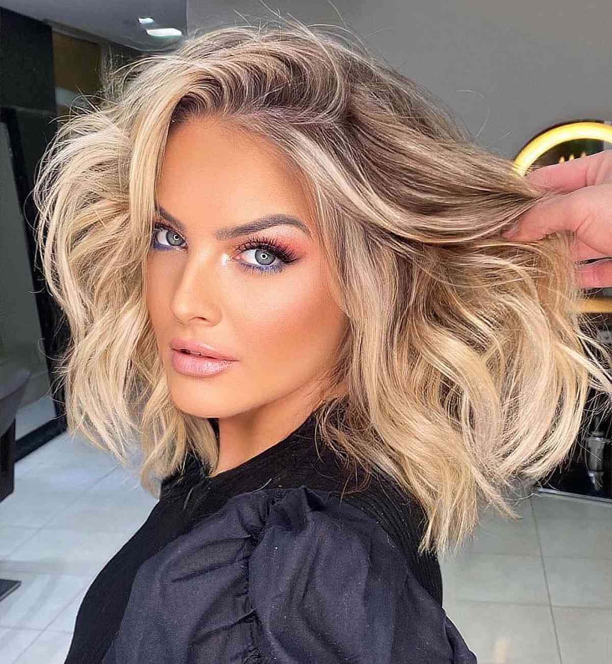 Light Blonde Highlighted Voluminous Waves and a Side Part