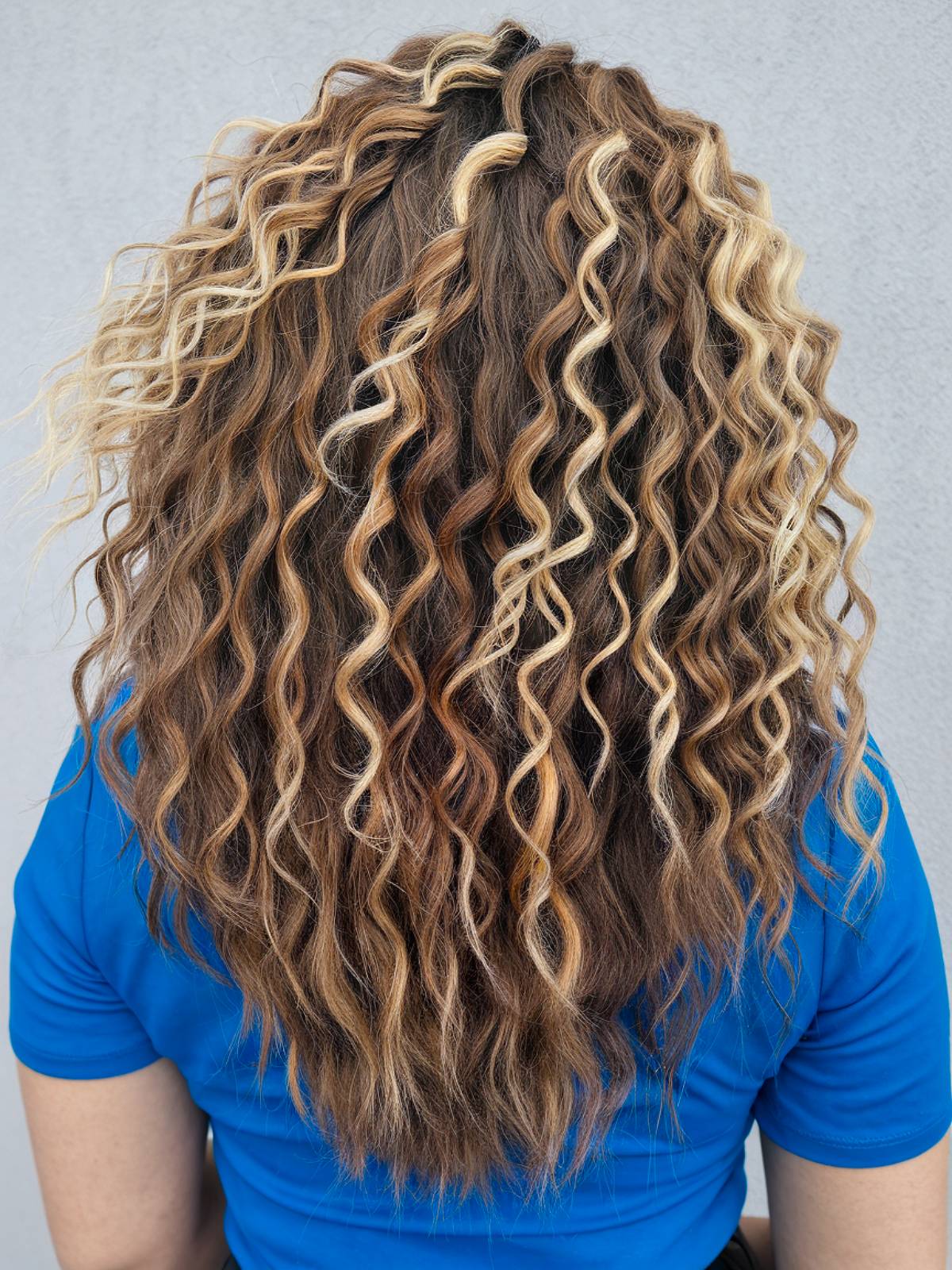 Light brown curly hair with balayage