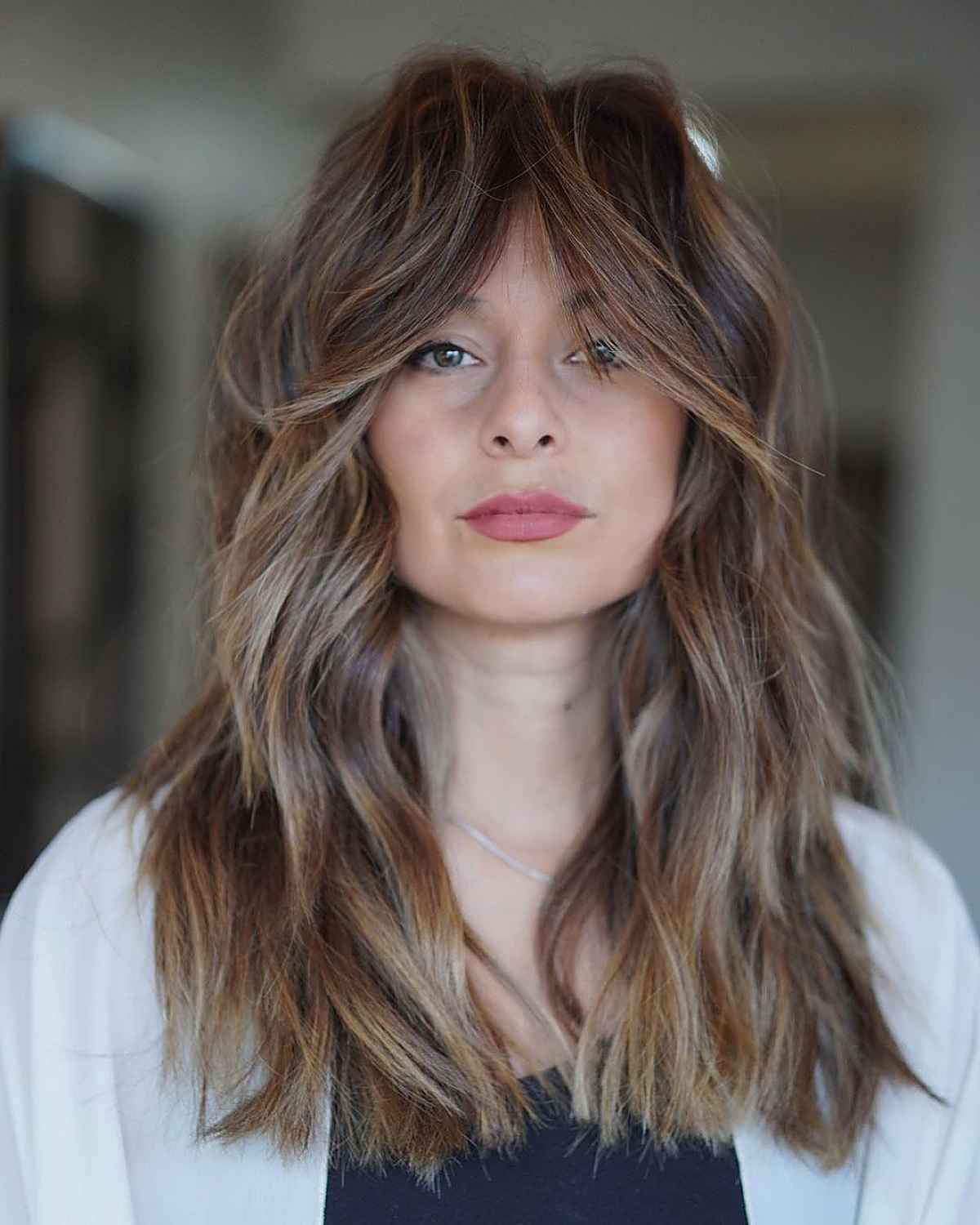 light brown hair color with face-framing blonde balayage highlights