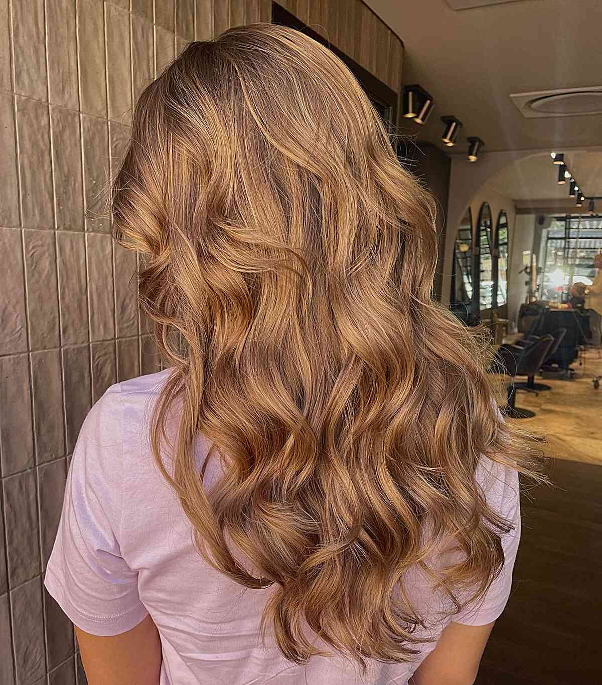Light Golden Brown Hair with Dark Roots on Wavy Layered Hair