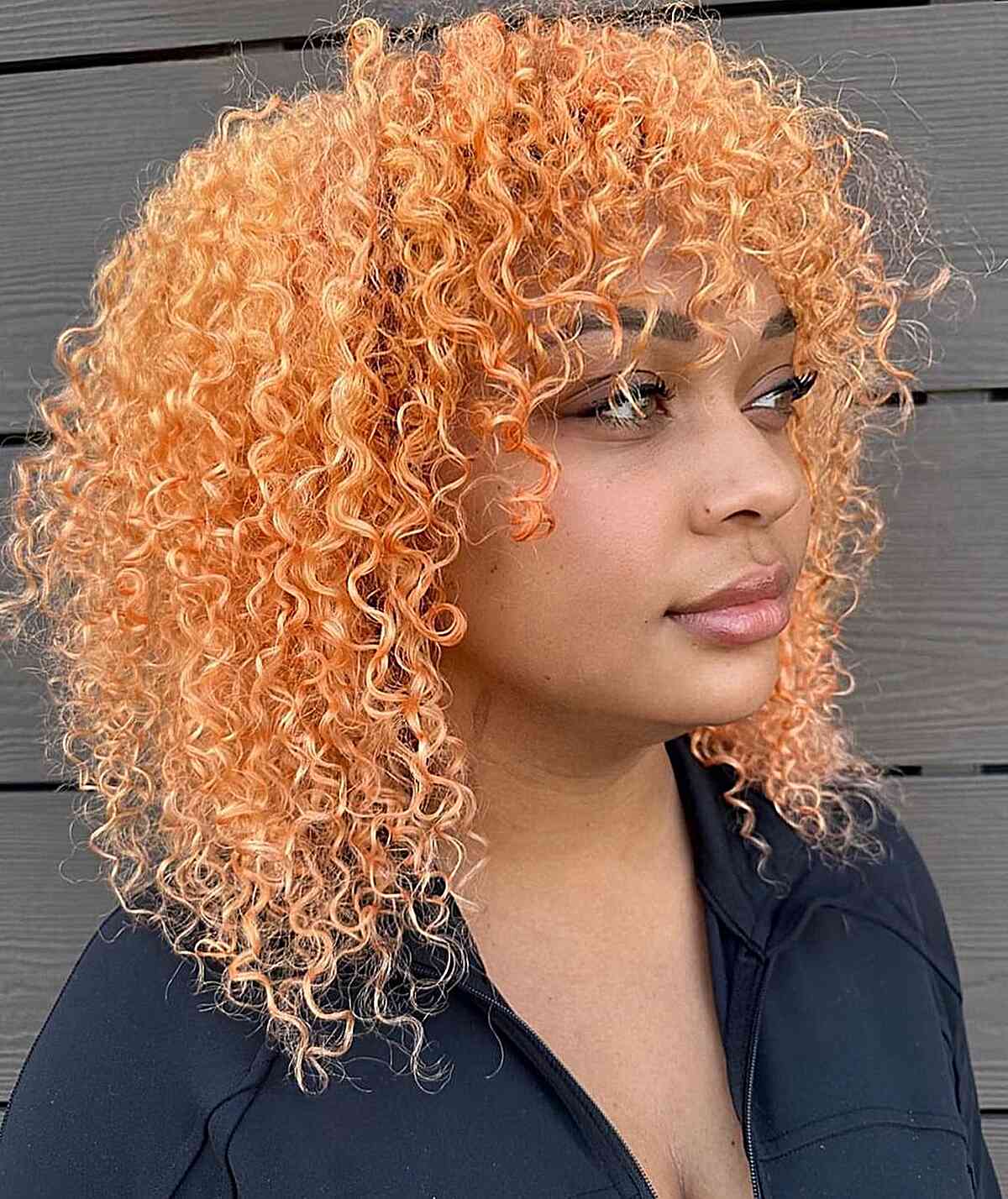 Shoulder-Length Light Peach Curly Hair with Bangs for Festivals
