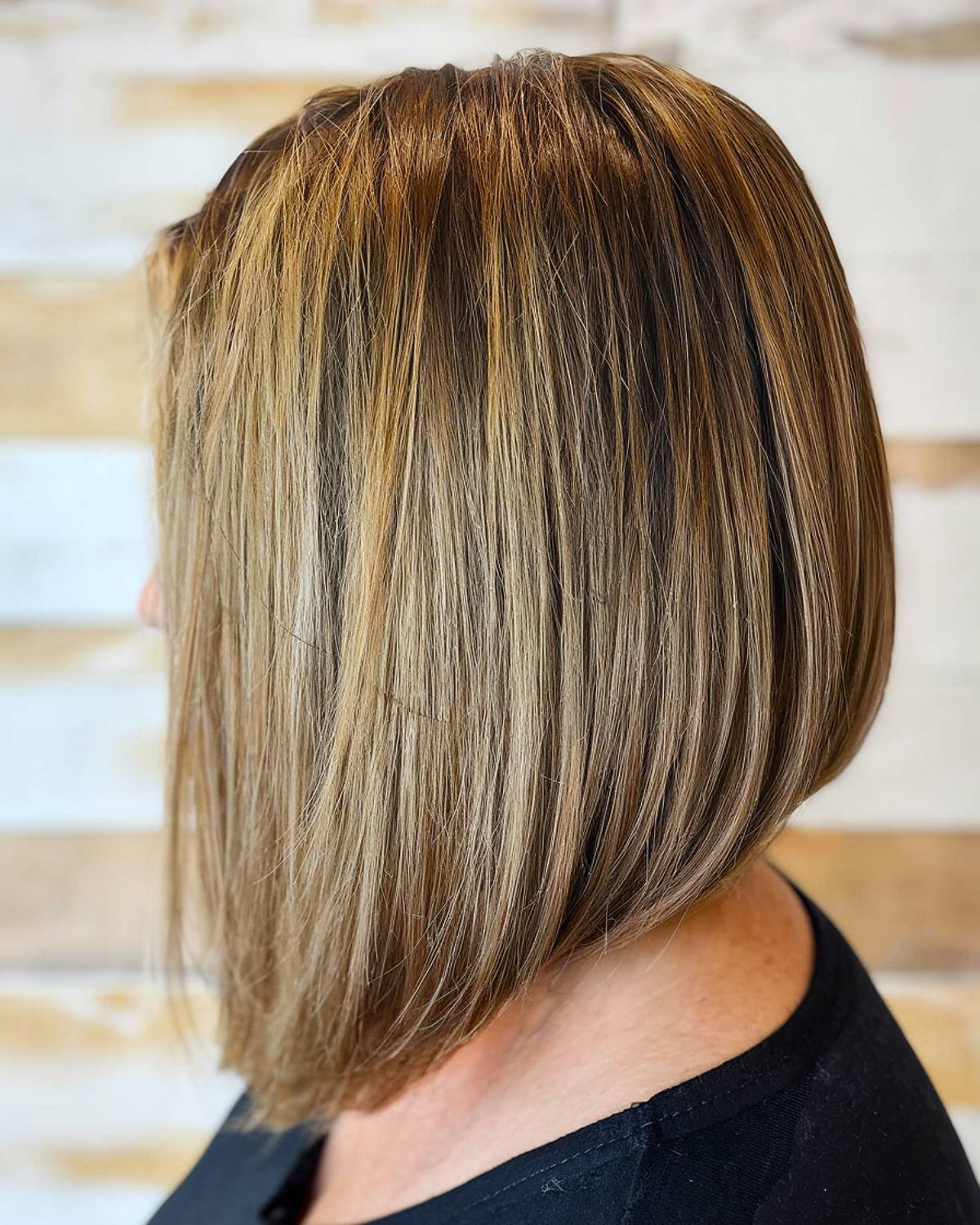 Long angled bob with a smooth finish and blended layers, great for older women who want a trendy yet sophisticated cut