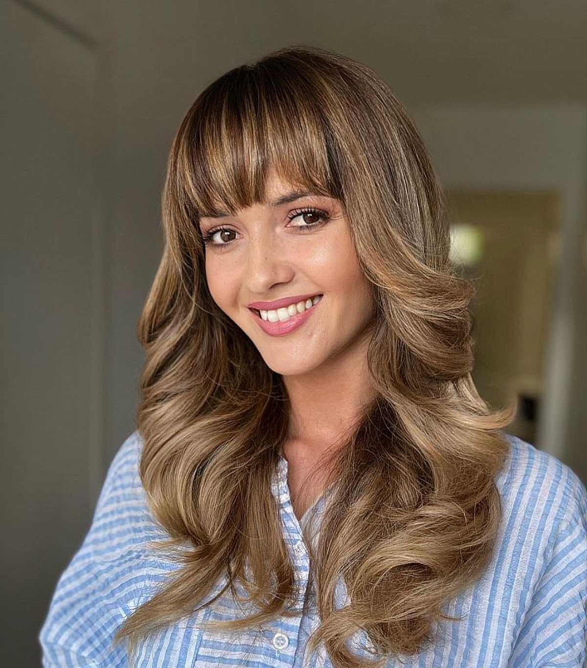 Long Blonde Balayage with Curled Ends and Fringe