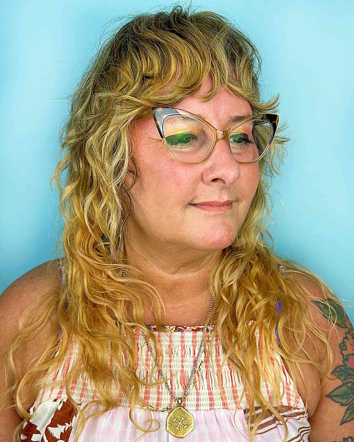 Long Blonde Shag with Loose Curls and Bangs for Women over 40