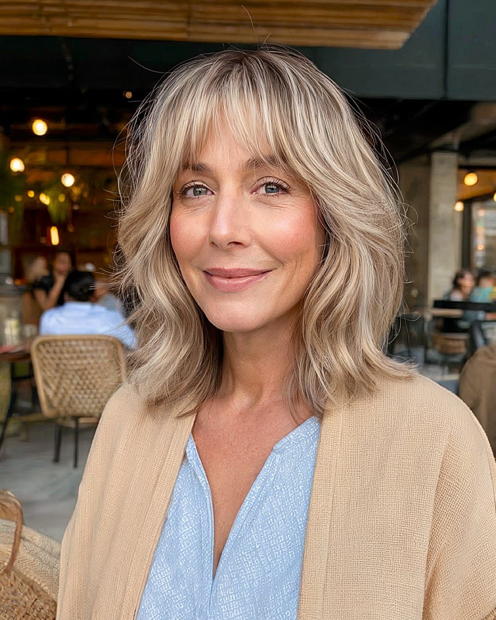 Layered long bob with curtain bangs for women over 50 wanting softness around the face