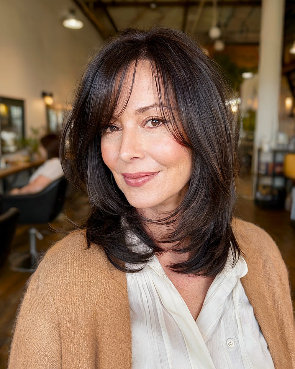Layered long bob with feathered ends for women over 50 wanting soft movement and face framing