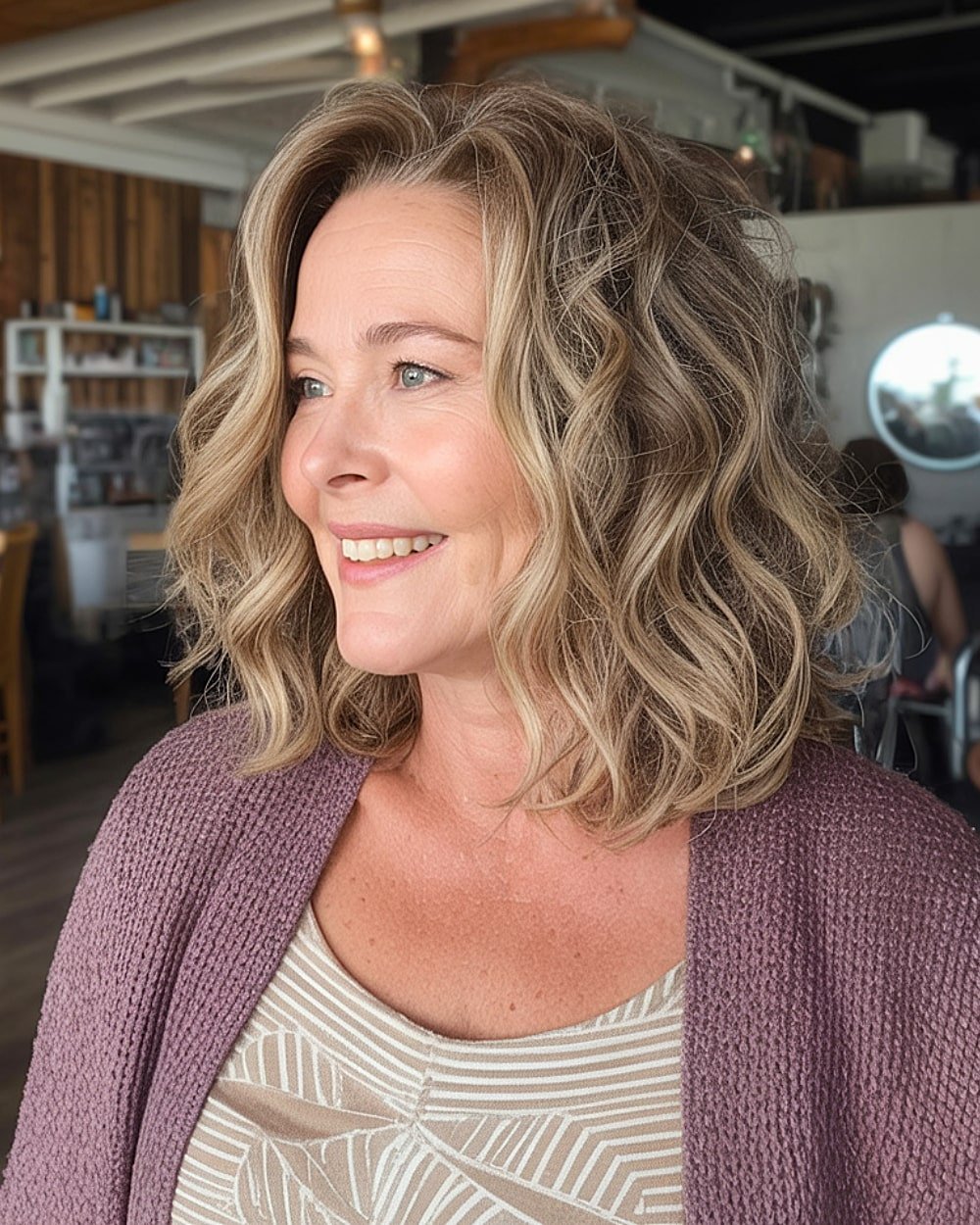 Soft wavy long bob with blonde highlights for women over 50 embracing natural texture