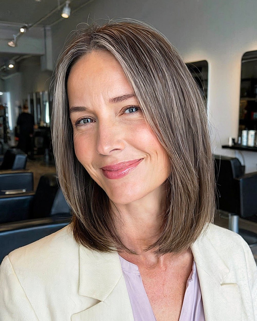 Straight long bob with subtle layers for mature women over 50 with sleek, low-maintenance style