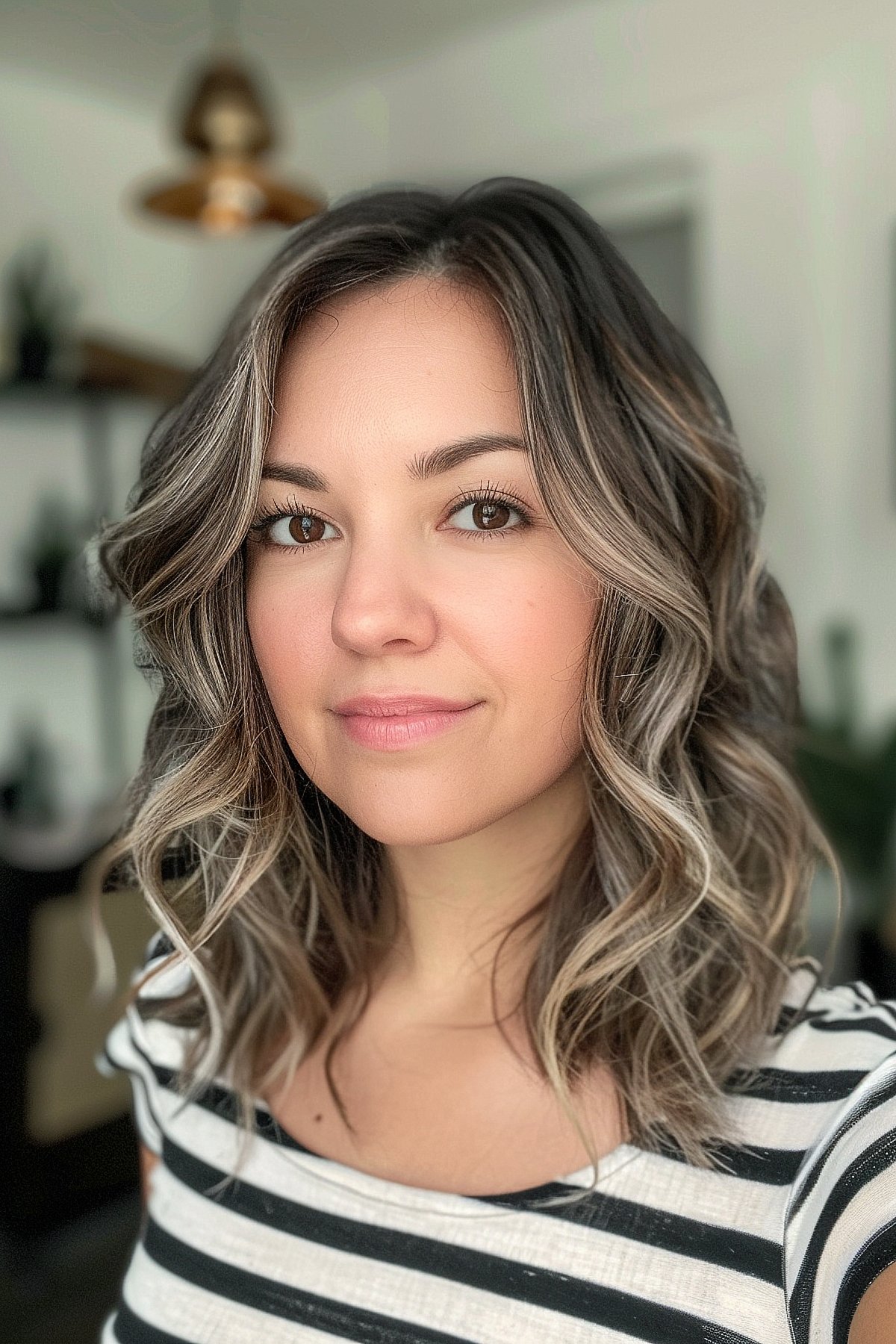 Woman with long bob styled in loose, defined waves, achieved through a digital perm