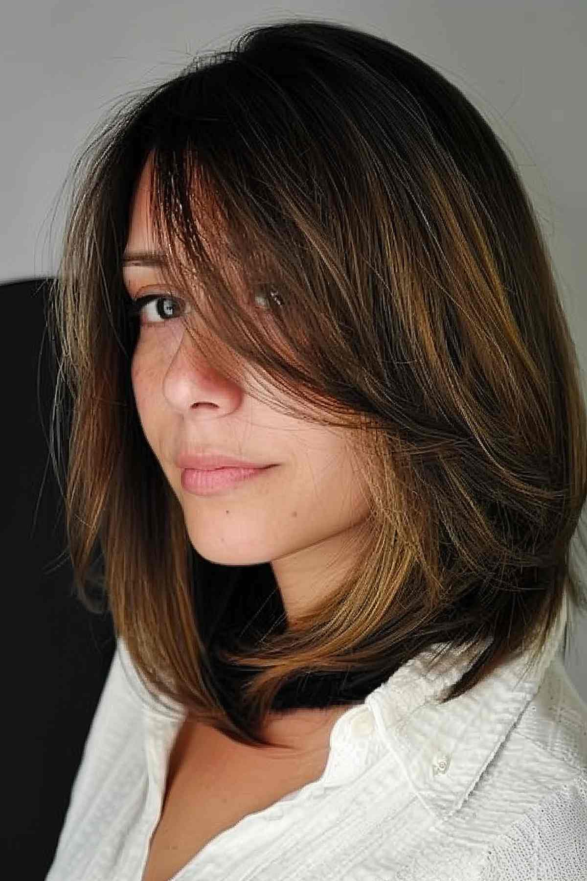 Long bob with side bangs and layers, perfect for medium to thick hair, adding volume and movement.