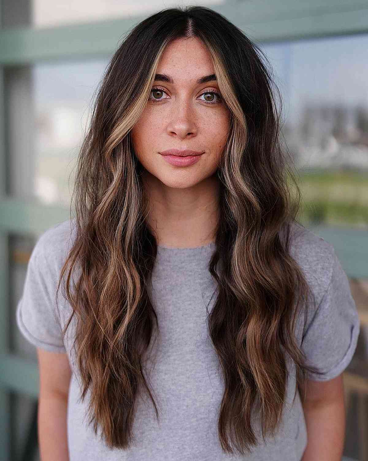 Long Brunette Hair with Loose Waves and a Money Piece
