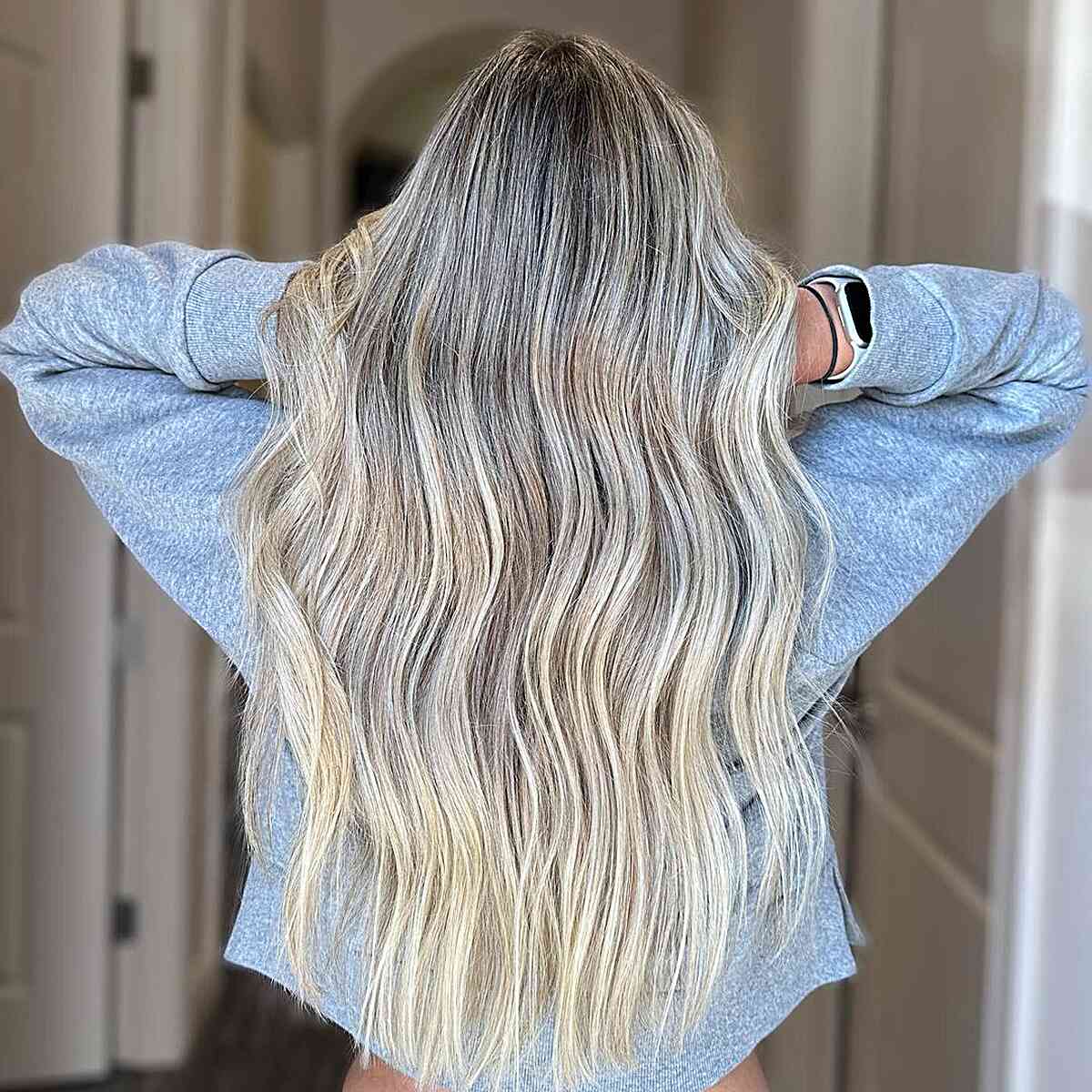 Long Icy Blonde Balayage Waves with Darker Roots and Soft Waves