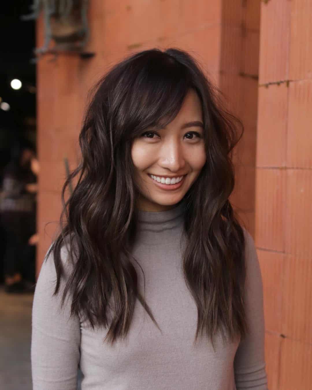 Long Hair with Long Layers and Side-Swept Bangs for a Rounder Face Shape