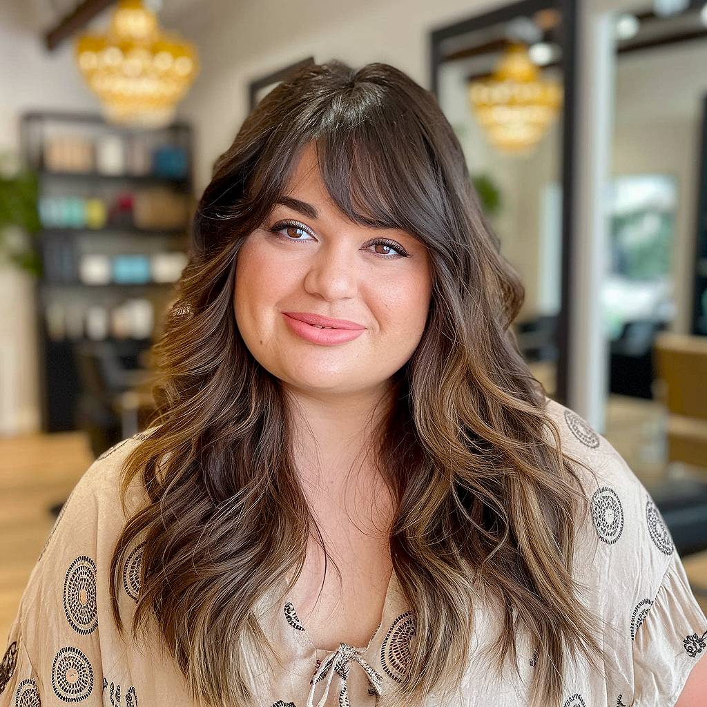 Flowing long layered haircut with side bangs for face-framing softness