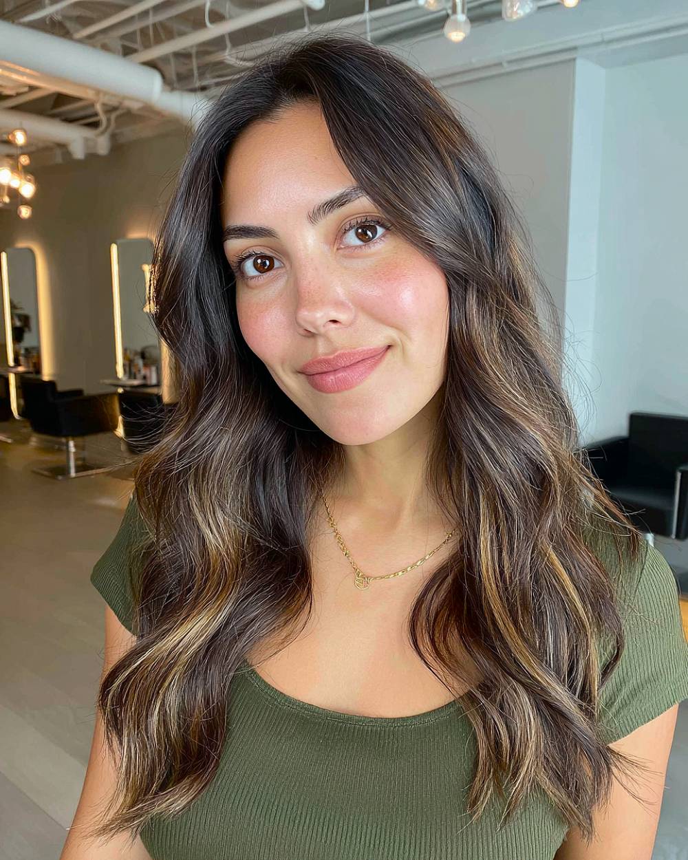 Long layered wavy hair with face-framing highlights, perfect for adding dimension and movement to natural waves