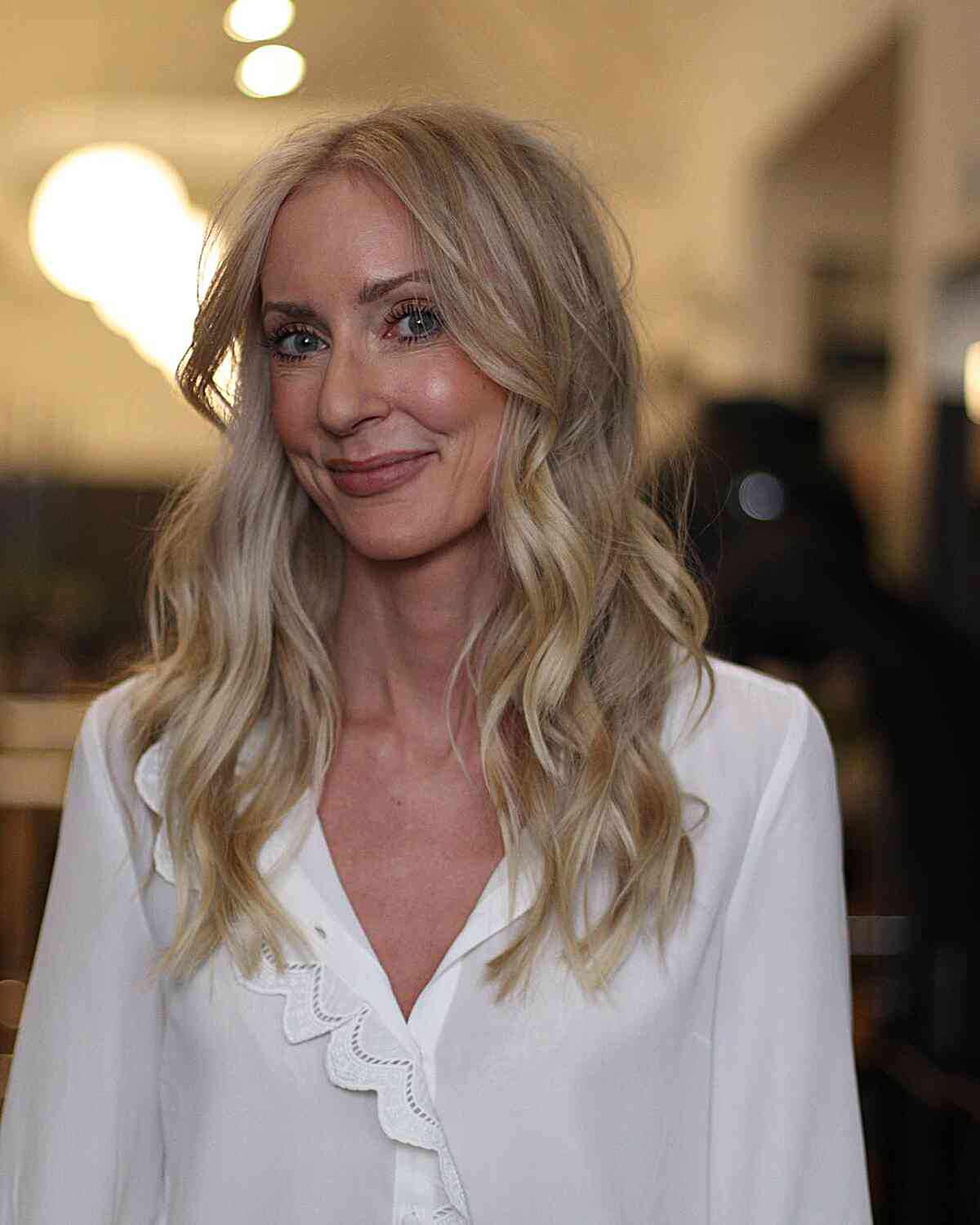 Long Layers and Long Curtain Fringe on Medium-Length Blonde Hair perfect for women in their 40s