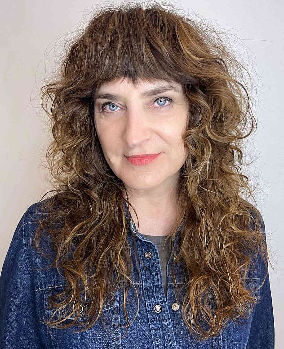 Long-Length Shagged Curly Hair with Textured Bangs on women 50 and up