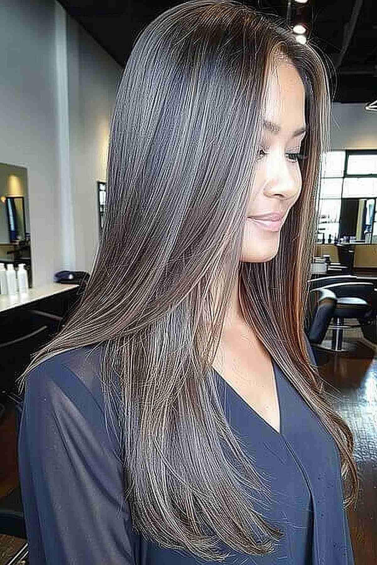 Long straight hair with metallic silver and ash brown tones for a youthful, modern look