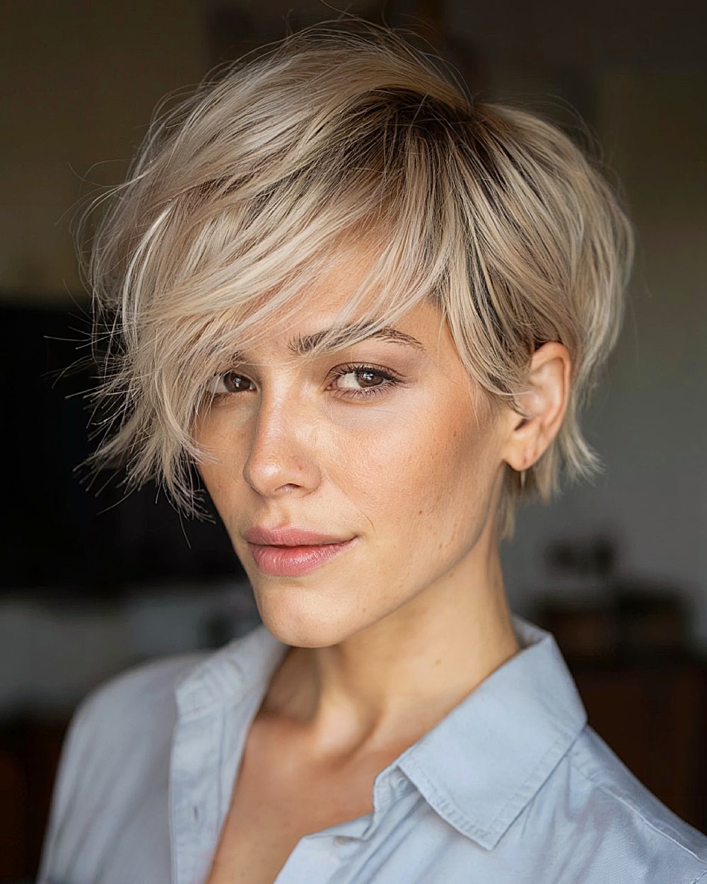 Flixie haircut with feathered layers and choppy blonde bangs for a textured modern look