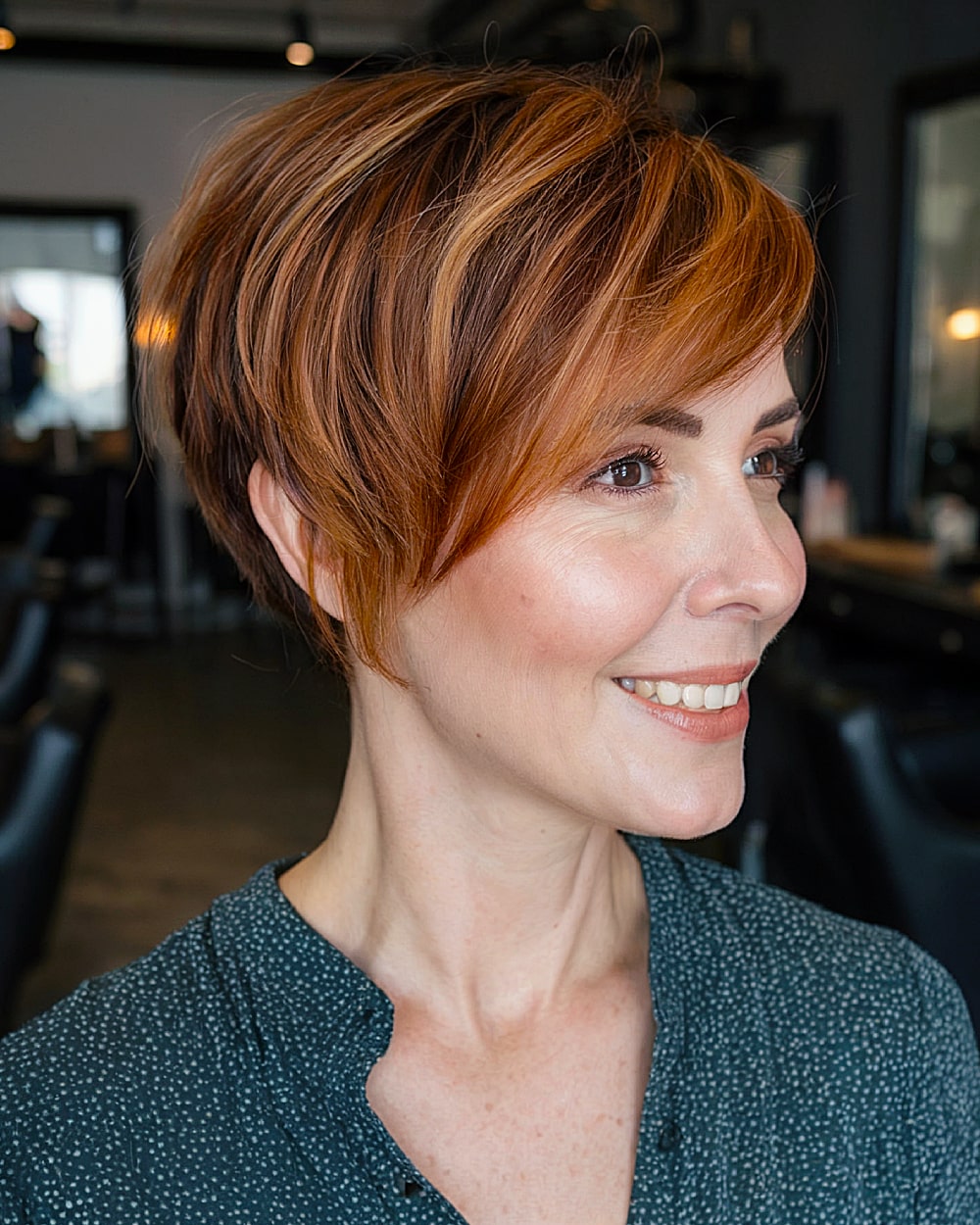 Graduated long pixie with layered back and copper highlights on auburn base