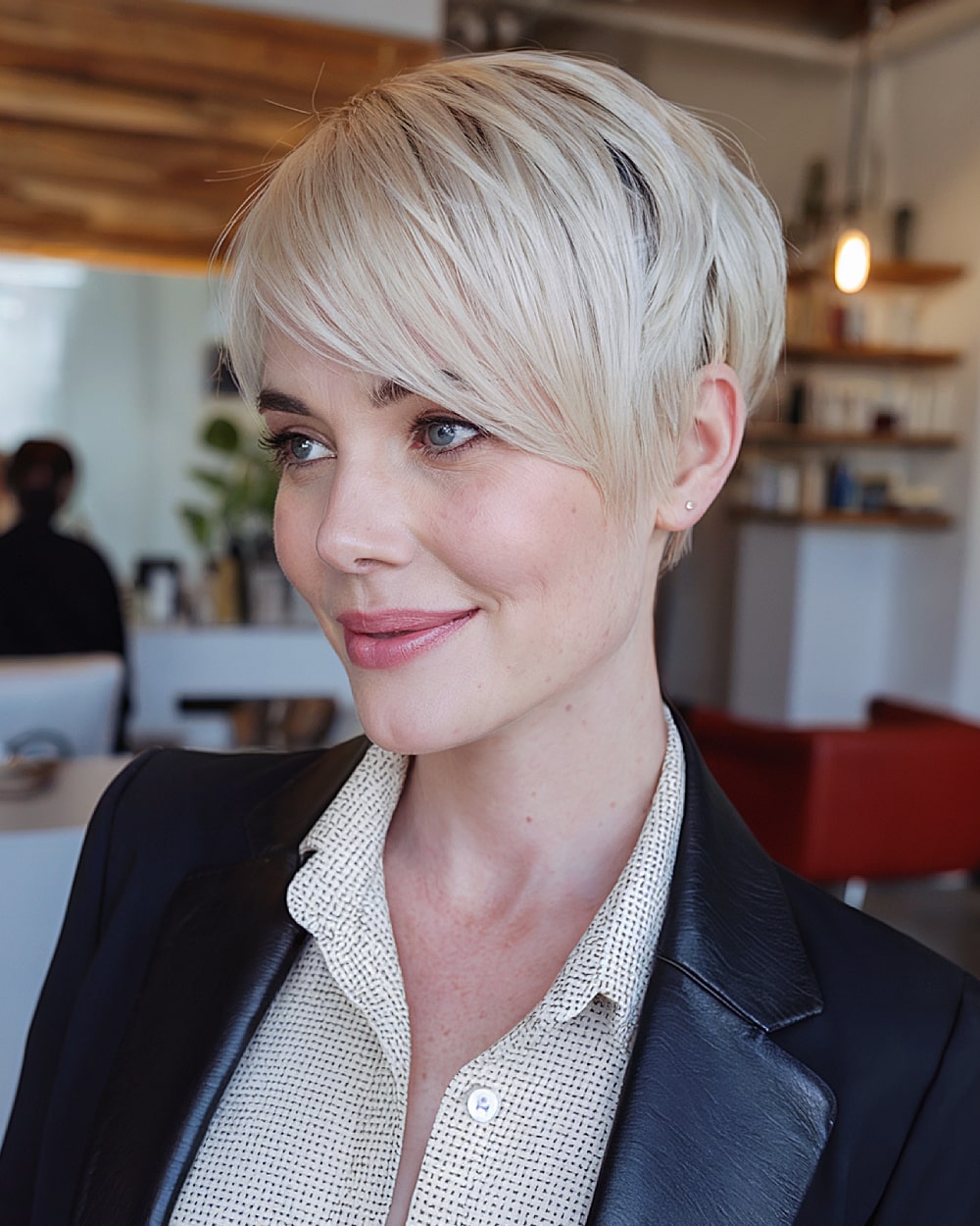Platinum blonde long pixie with textured layers and side part for bright, edgy style