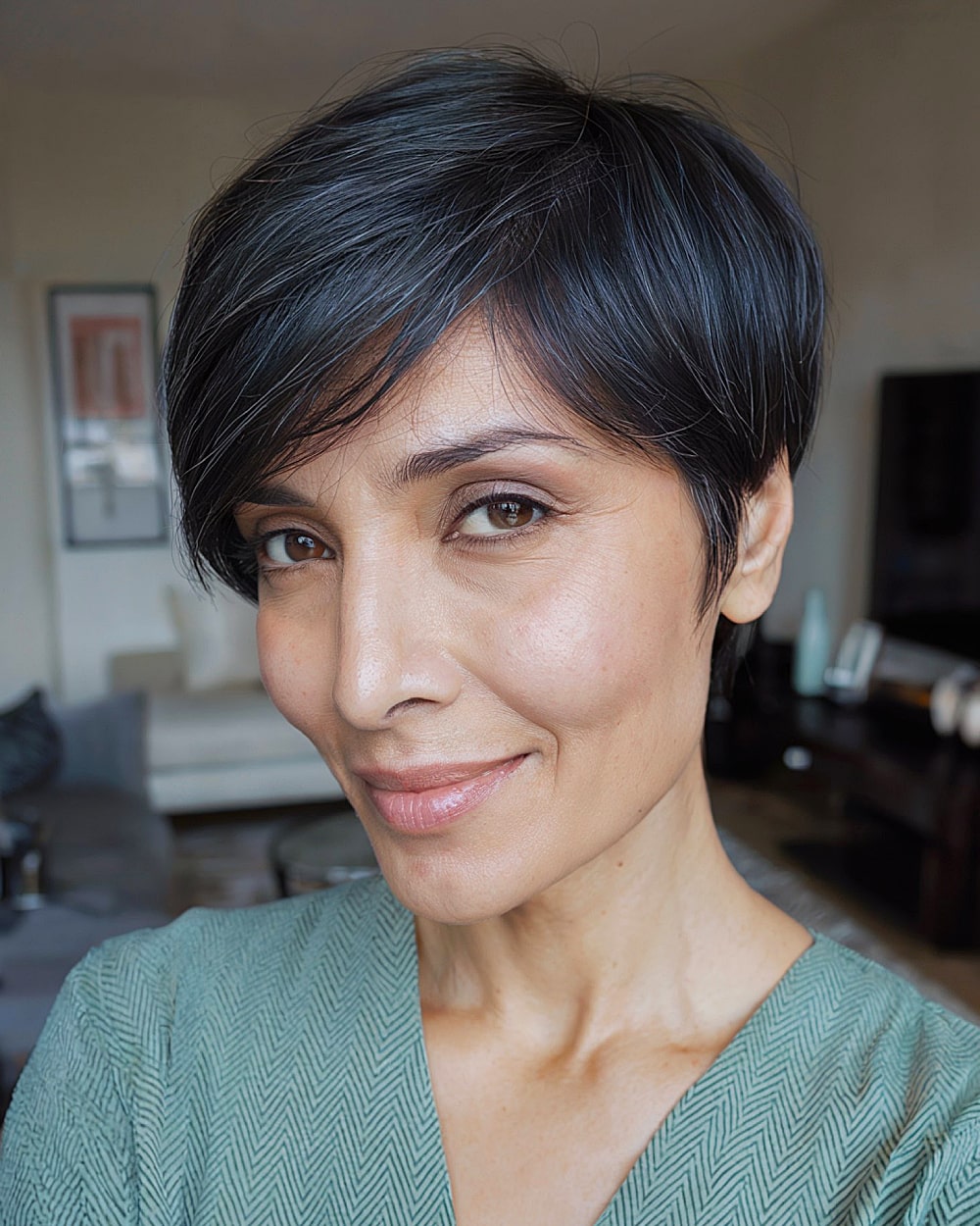 Smooth long pixie haircut with clean lines and tapered nape for straight hair