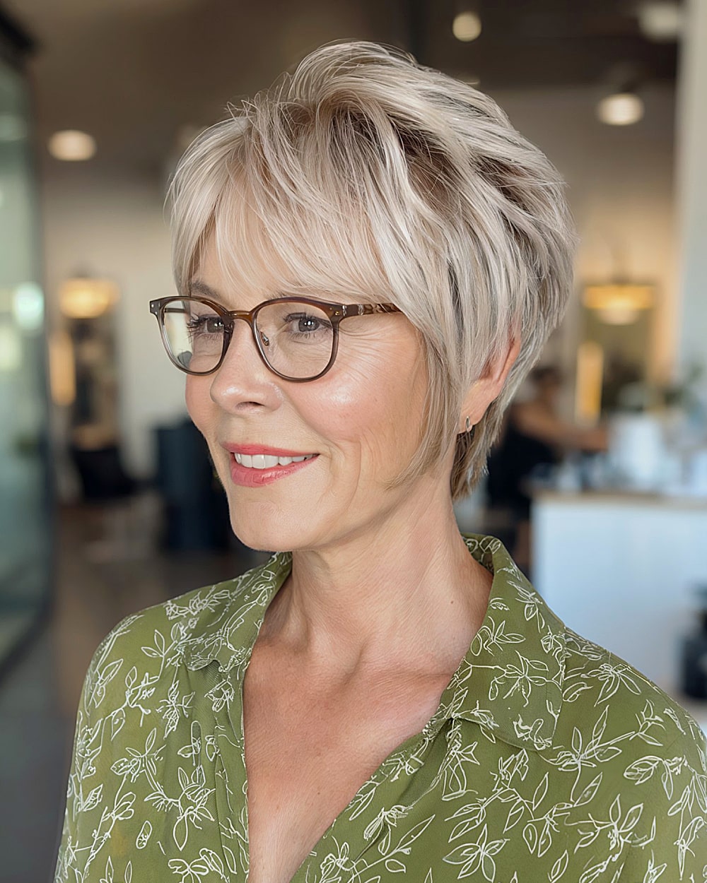 Stacked long pixie cut with tapered back and wispy layers for added crown volume