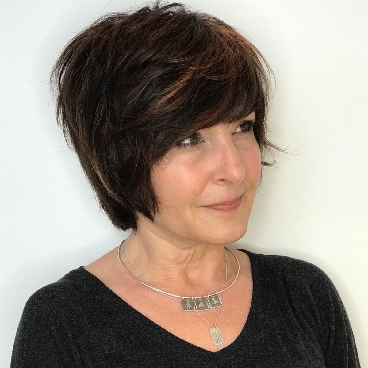 Long pixie with feathered layers for women over 50 with thick hair