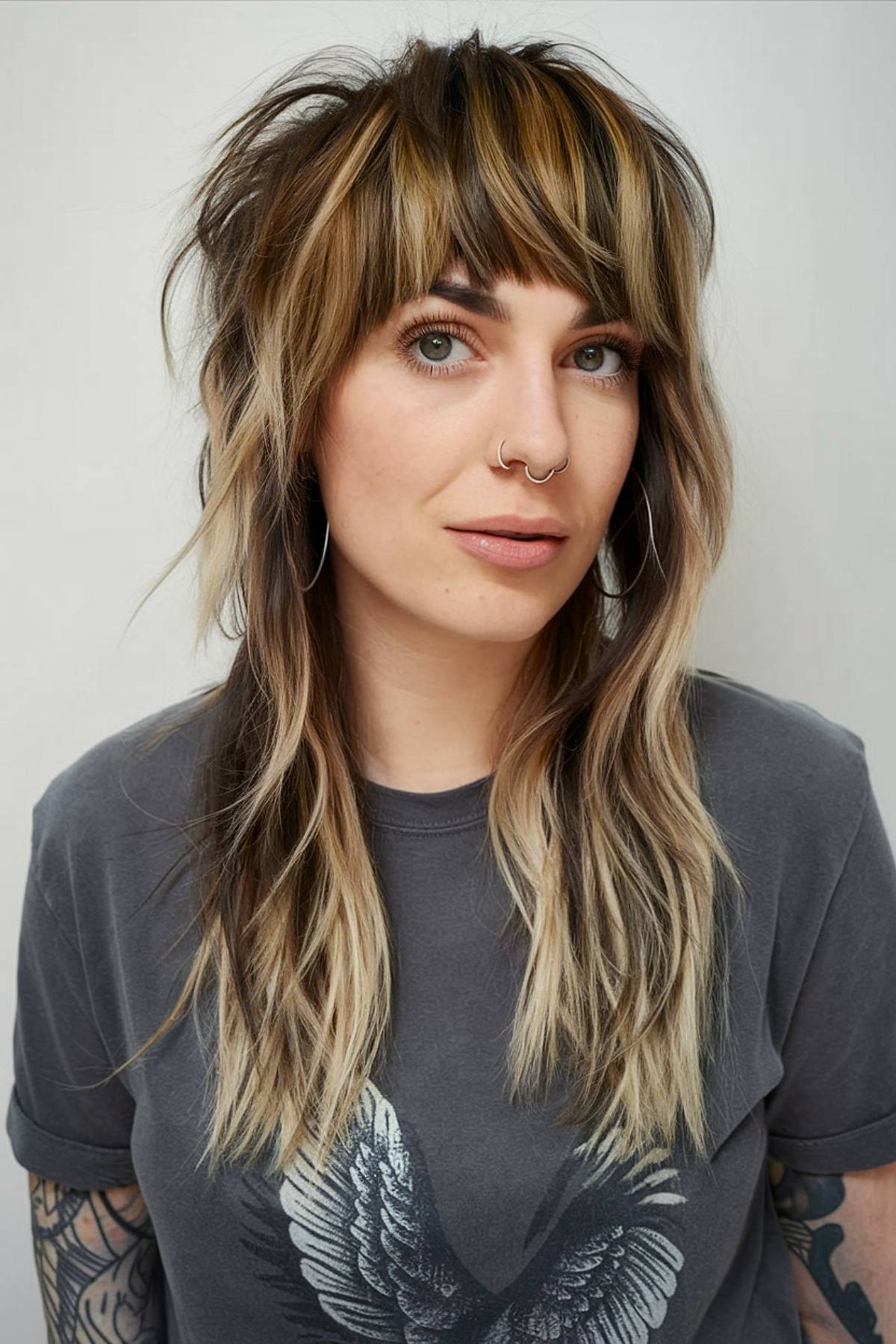 Long shaggy mullet with face-framing layers and textured bangs for a laid-back, boho feel