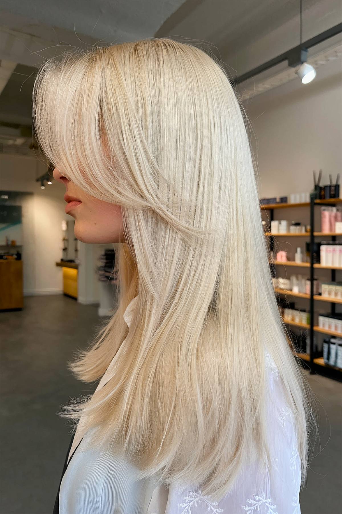 Long straight blonde hair with curtain bangs hairstyle